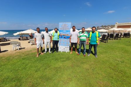 Coastal Cleanup with TouMaLi banner on grass 